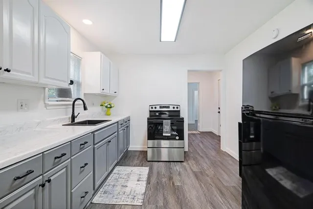 a kitchen with sink cabinets and stainless steel appliances