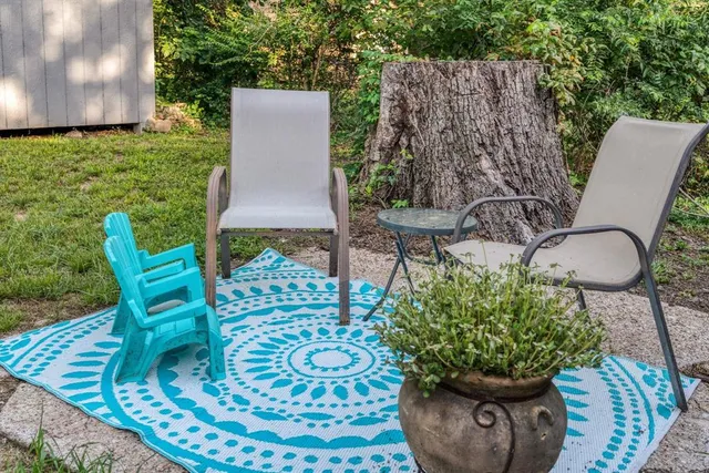 a view of a chairs and table in the patio