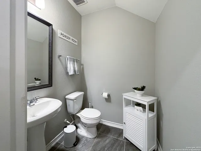 a white toilet sitting next to a bathroom sink