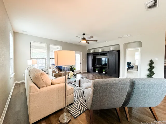 a living room with furniture and a large window