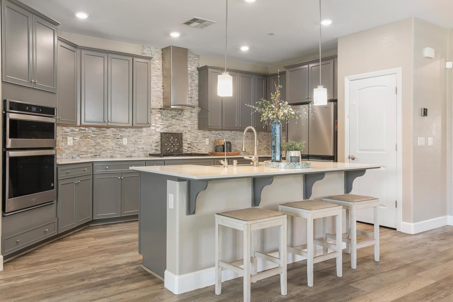 1676 Red Ribbons Lane Manteca, CA 95337 - Photo 1 of 33 a kitchen with kitchen island granite countertop a sink and cabinets