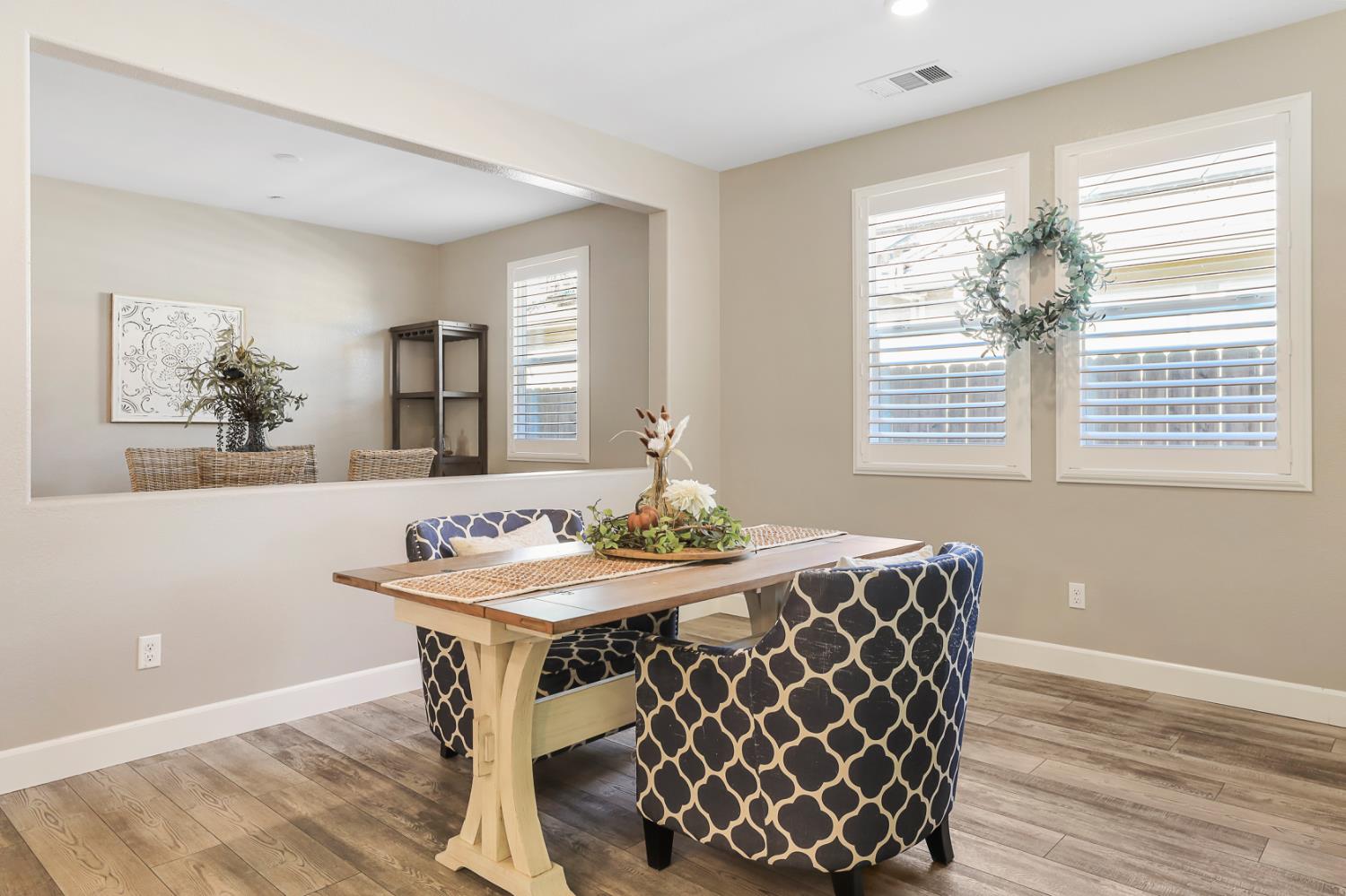 1676 Red Ribbons Lane Manteca, CA 95337 - Photo 13 of 33 a view of a dining room with furniture window and wooden floor