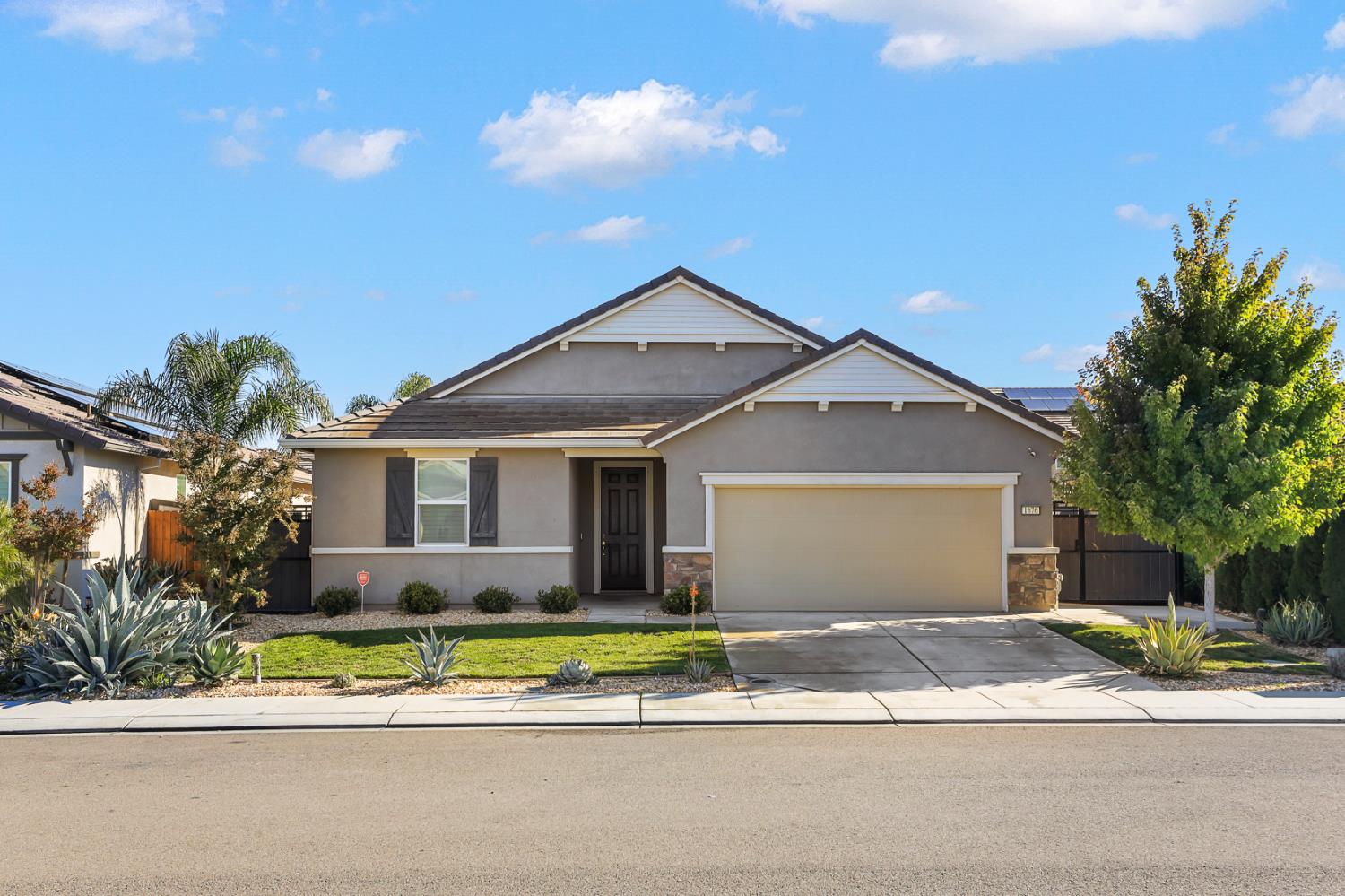 1676 Red Ribbons Lane Manteca, CA 95337 - Photo 28 of 33 a front view of a house with a yard and garage