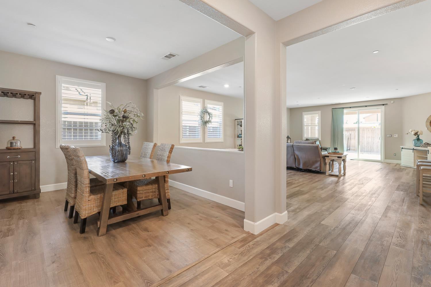 1676 Red Ribbons Lane Manteca, CA 95337 - Photo 8 of 33 a view of a dining room with furniture and wooden floor