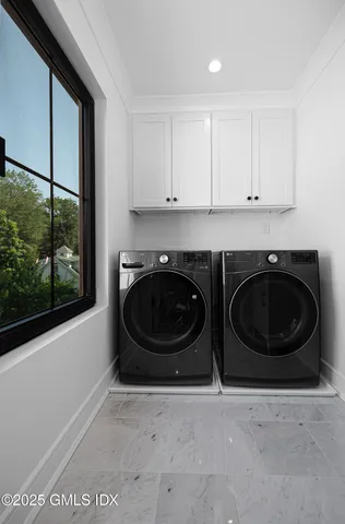 a utility room with sink dryer and washer