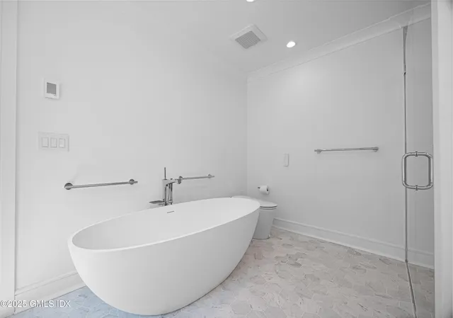 a white bath tub sitting in a bathroom