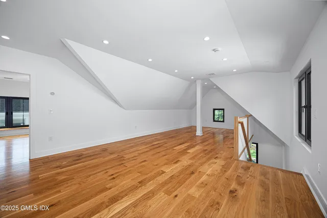 a view of an empty room with wooden floor