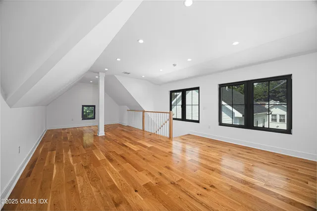 a bedroom with a large bed and window
