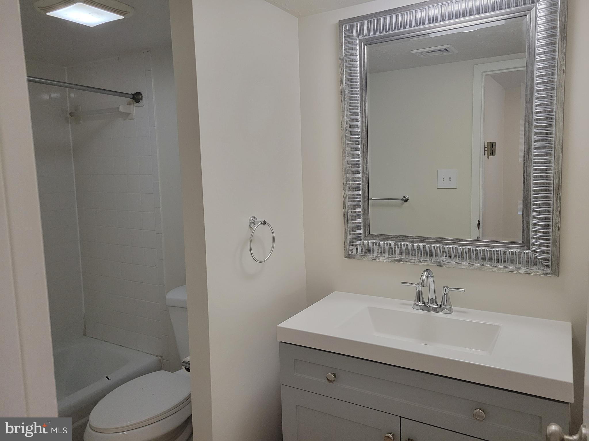 8431 Greenbelt Road Greenbelt, MD 20770 - Photo 7 of 16 a bathroom with a sink toilet and shower