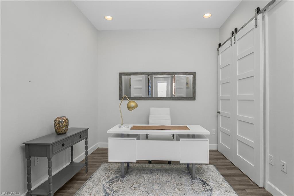 6907 Cay Court Naples, FL 34113 - Photo 12 of 50 Office space featuring a barn door (closet), Tile-wood-type flooring, and recessed lighting