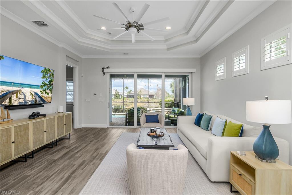 6907 Cay Court Naples, FL 34113 - Photo 15 of 50 Great room featuring ceiling fan, Tile floors, ornamental molding, and recessed lighting, Plantation Shutters