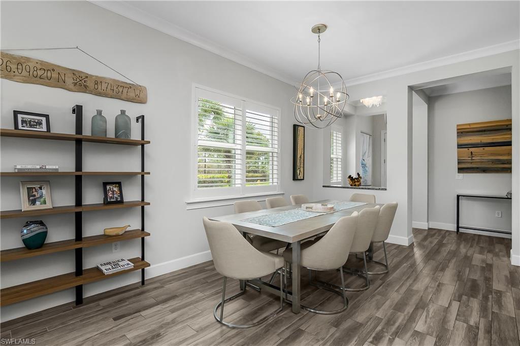 6907 Cay Court Naples, FL 34113 - Photo 16 of 50 Dining space featuring crown molding, a chandelier, Note the Abundance of Natural Light