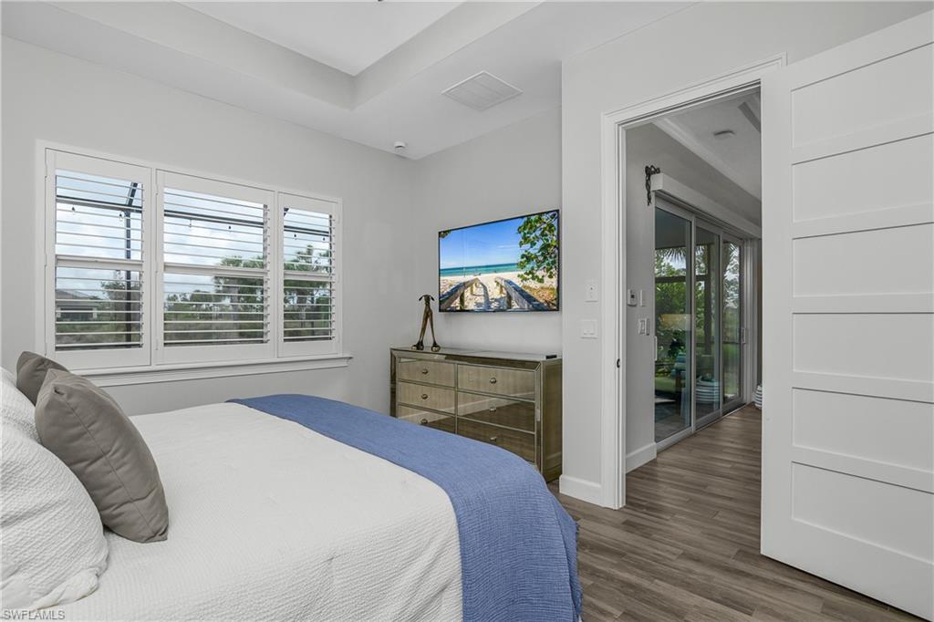 6907 Cay Court Naples, FL 34113 - Photo 26 of 50 Owner's Bedroom with volume ceilings, large windows with Plantation Shutters, 8' Shaker Style Doors