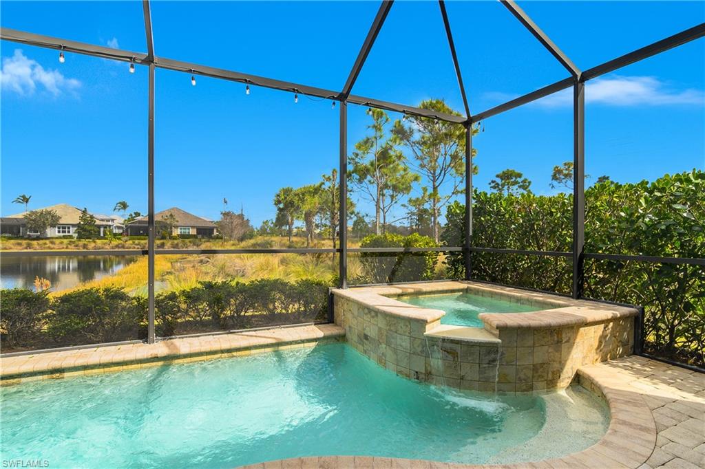 6907 Cay Court Naples, FL 34113 - Photo 31 of 50 Relaxing pool / spa with a lanai and a sunroom