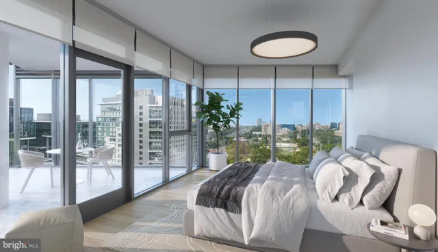 a bed sitting in a bedroom next to a large window