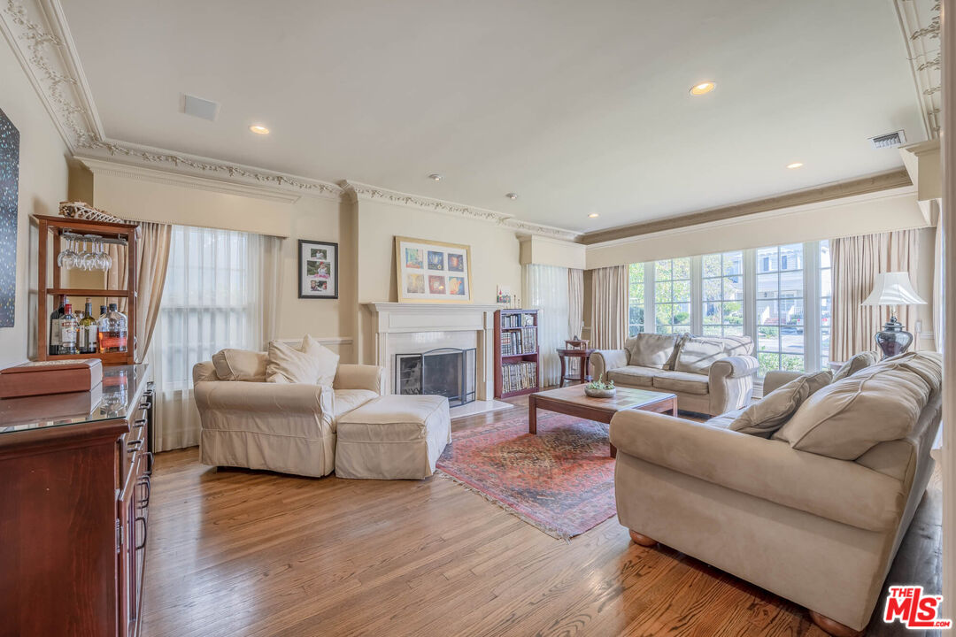 9038 Cresta Drive Los Angeles, CA 90035 - Photo 2 of 23 a living room with fireplace furniture and a wooden floor