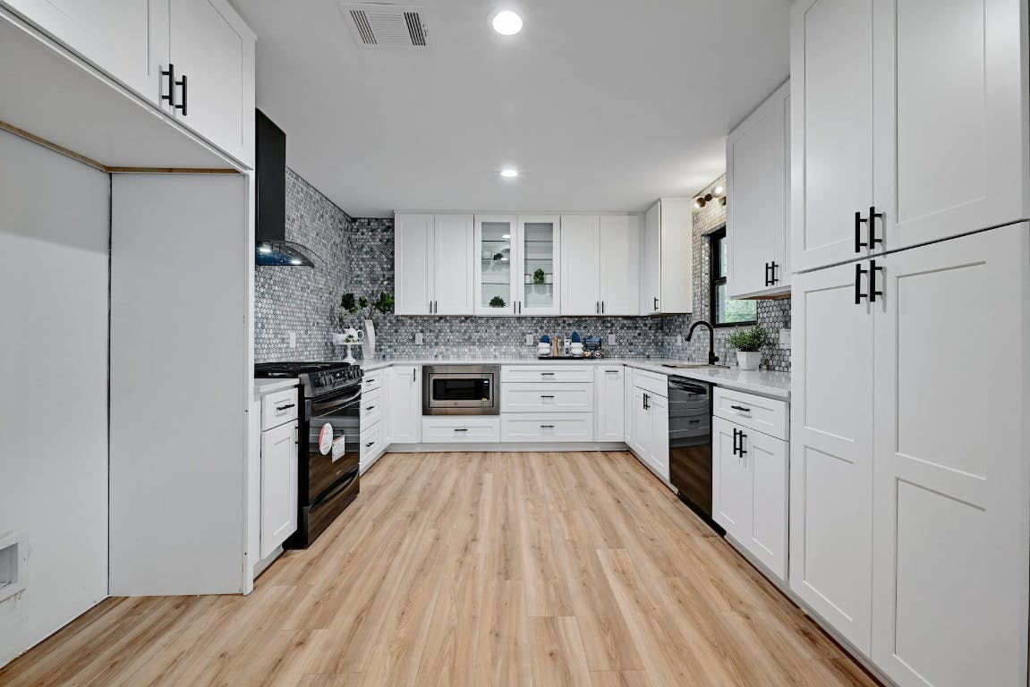 4604 Nevada Path Austin, TX 78745 - Photo 5 of 10 a kitchen with white cabinets stainless steel appliances and sink