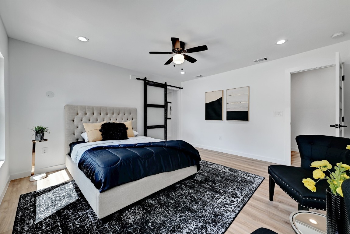 4604 Nevada Path Austin, TX 78745 - Photo 6 of 10 a bedroom with a bed wooden floor and a fireplace