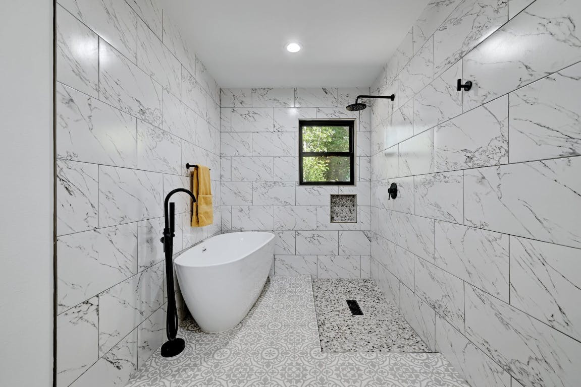 4604 Nevada Path Austin, TX 78745 - Photo 7 of 10 a bathroom with a bathtub and shower