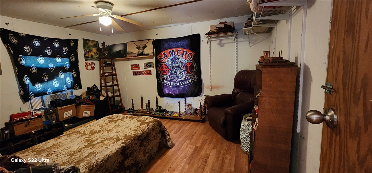 326 Doyle Street Westminster, SC 29693 - Photo 16 of 26 This inviting bedroom features rich wood flooring, offering a comfortable and warm retreat.