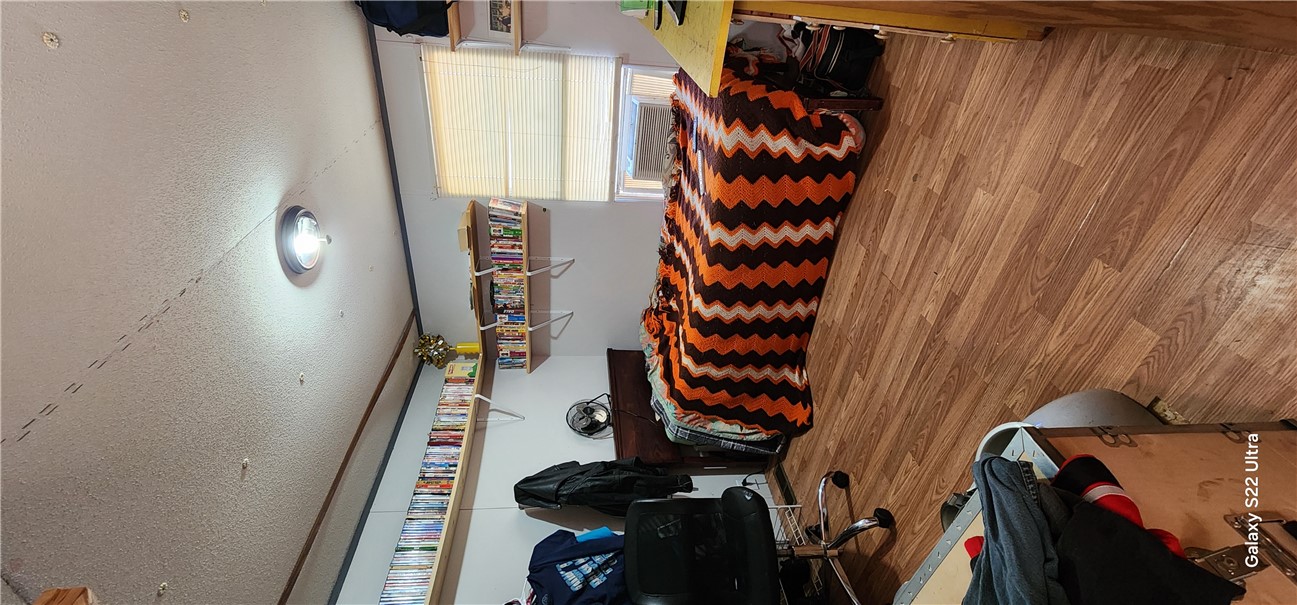 326 Doyle Street Westminster, SC 29693 - Photo 17 of 26 This cozy bedroom features warm wood flooring and convenient built-in shelving, perfect for a personalized retreat.