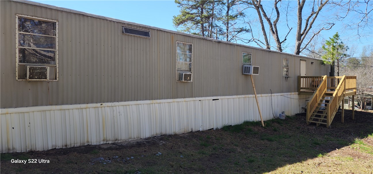 326 Doyle Street Westminster, SC 29693 - Photo 23 of 26 This manufactured home offers functional exterior features including practical window units and a sturdy wooden deck.