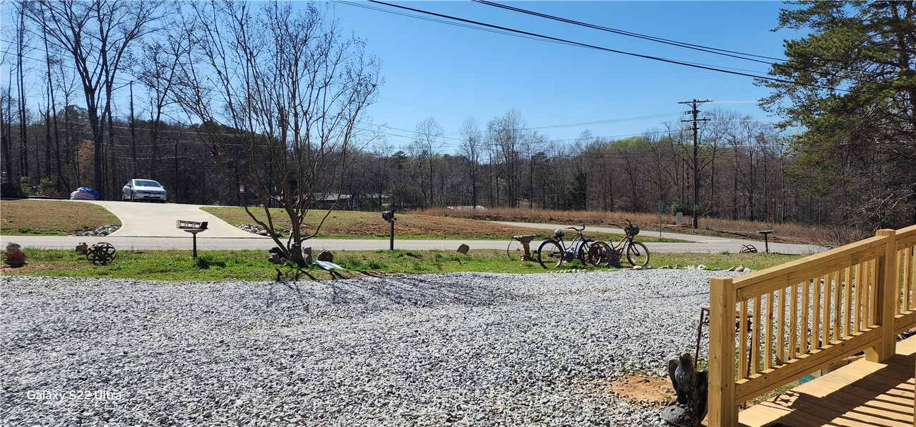 326 Doyle Street Westminster, SC 29693 - Photo 25 of 26 This expansive lot features a spacious driveway and a charming wooden deck, perfect for outdoor enjoyment.