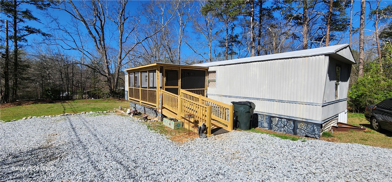 326 Doyle Street Westminster, SC 29693 - Photo 3 of 26 This charming home offers a tranquil escape with a screened porch, surrounded by lush natural landscaping.