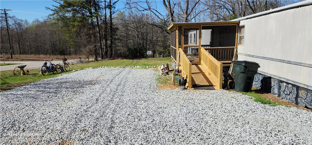 326 Doyle Street Westminster, SC 29693 - Photo 4 of 26 This charming home offers a spacious gravel driveway and a welcoming screened porch, perfect for outdoor living.