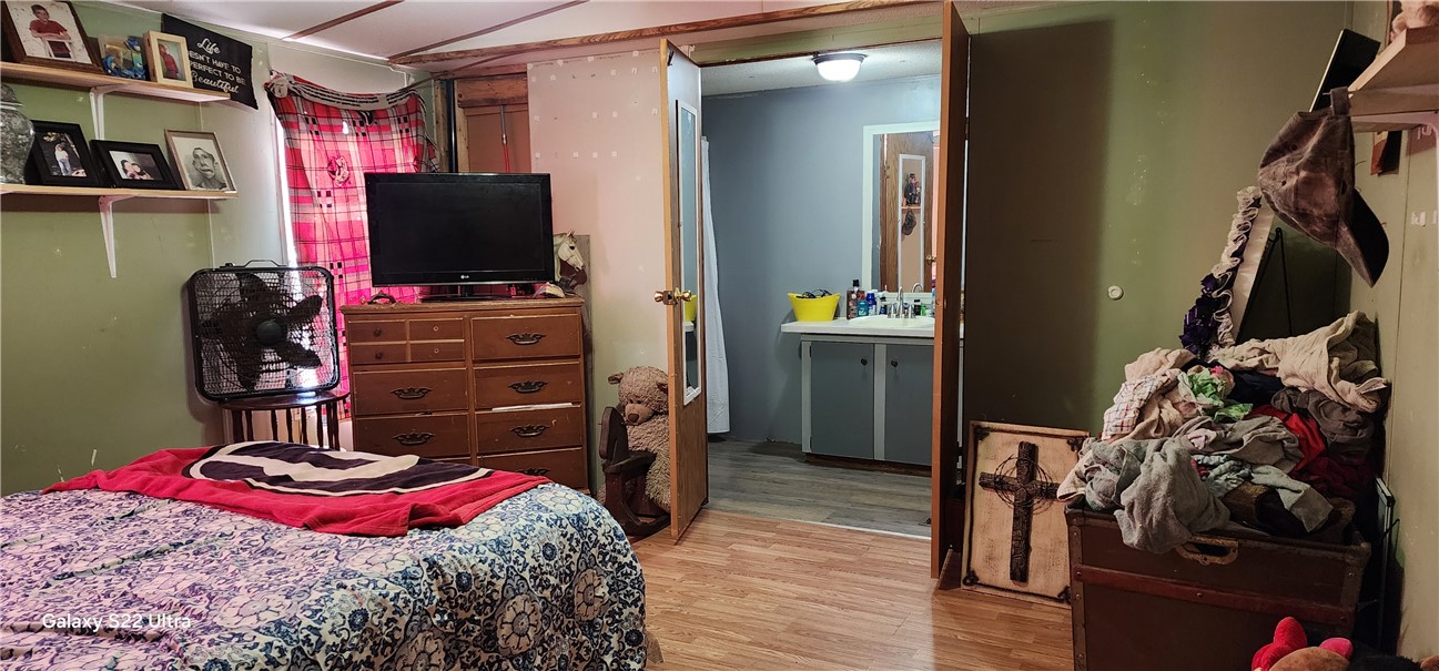 326 Doyle Street Westminster, SC 29693 - Photo 10 of 26 This cozy bedroom features warm wooden flooring, offering a comfortable and inviting personal retreat.