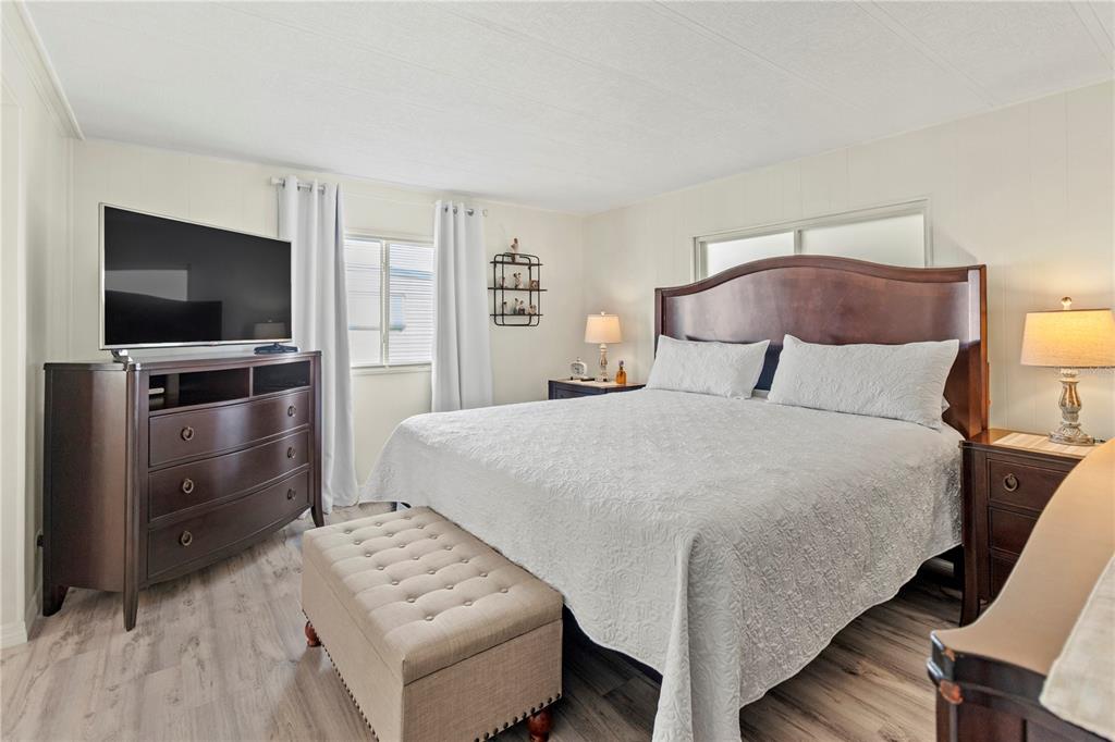 5619 Bayshore Road, Unit 240 Palmetto, FL 34221 - Photo 13 of 33 a bedroom with a bed and a flat screen tv