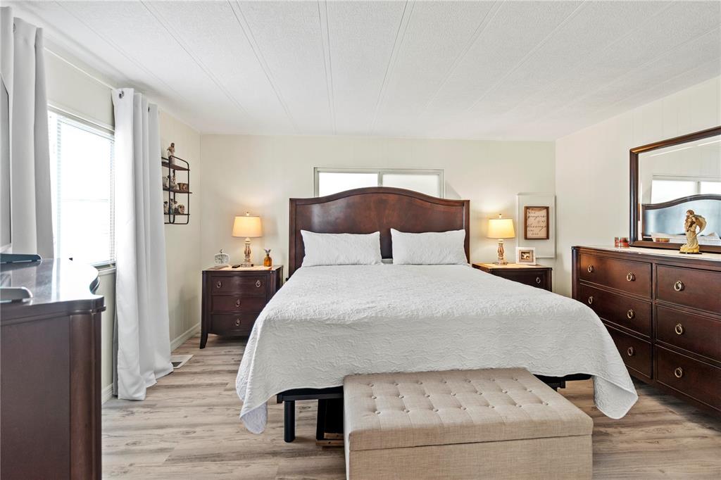 5619 Bayshore Road, Unit 240 Palmetto, FL 34221 - Photo 14 of 33 a bedroom with a bed and wooden floor