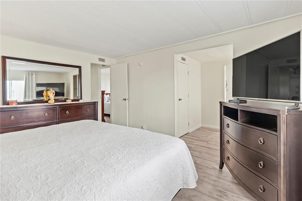 5619 Bayshore Road, Unit 240 Palmetto, FL 34221 - Photo 15 of 33 a bedroom with a bed and a dresser