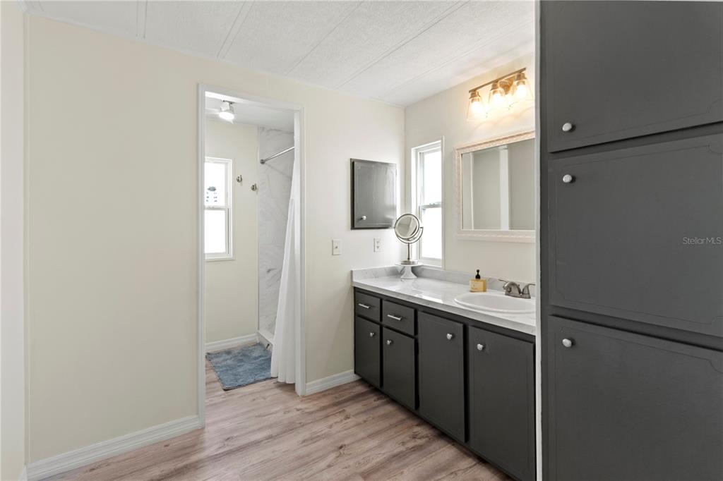 5619 Bayshore Road, Unit 240 Palmetto, FL 34221 - Photo 16 of 33 a bathroom with a sink and mirror