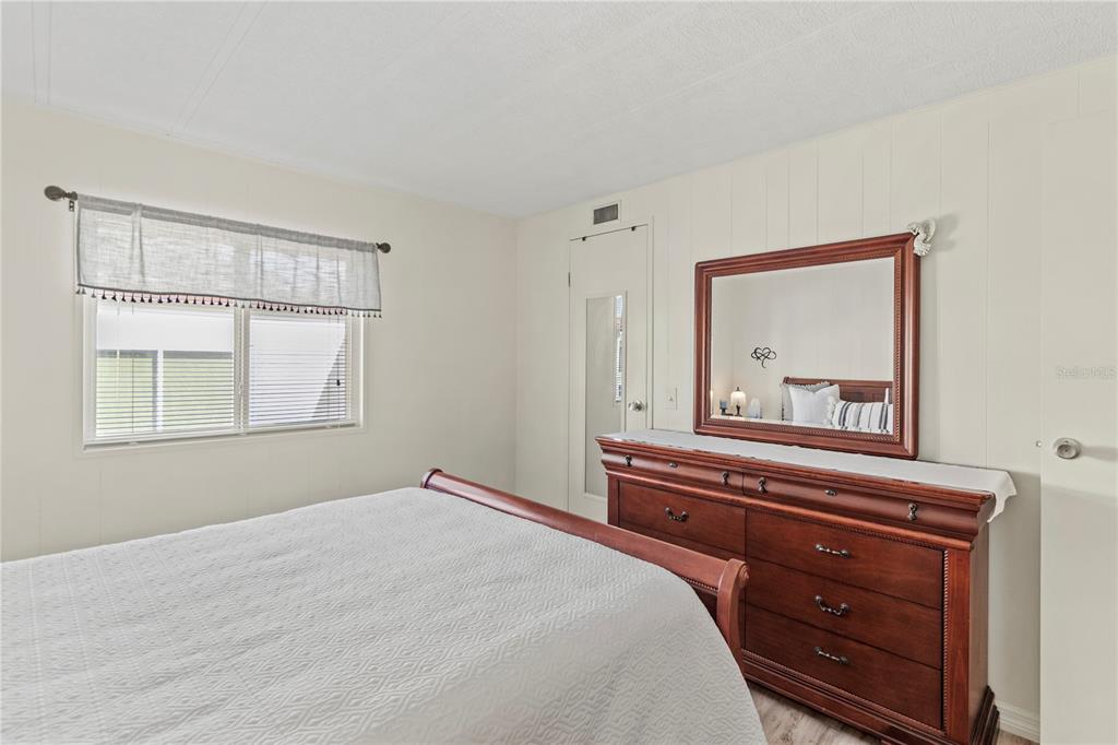 5619 Bayshore Road, Unit 240 Palmetto, FL 34221 - Photo 23 of 33 a bedroom with a bed and a dresser