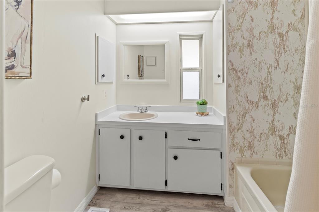 5619 Bayshore Road, Unit 240 Palmetto, FL 34221 - Photo 24 of 33 a bathroom with a sink a tub and a mirror