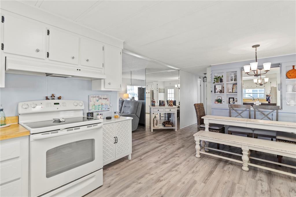 5619 Bayshore Road, Unit 240 Palmetto, FL 34221 - Photo 7 of 33 a kitchen with white cabinets and white appliances