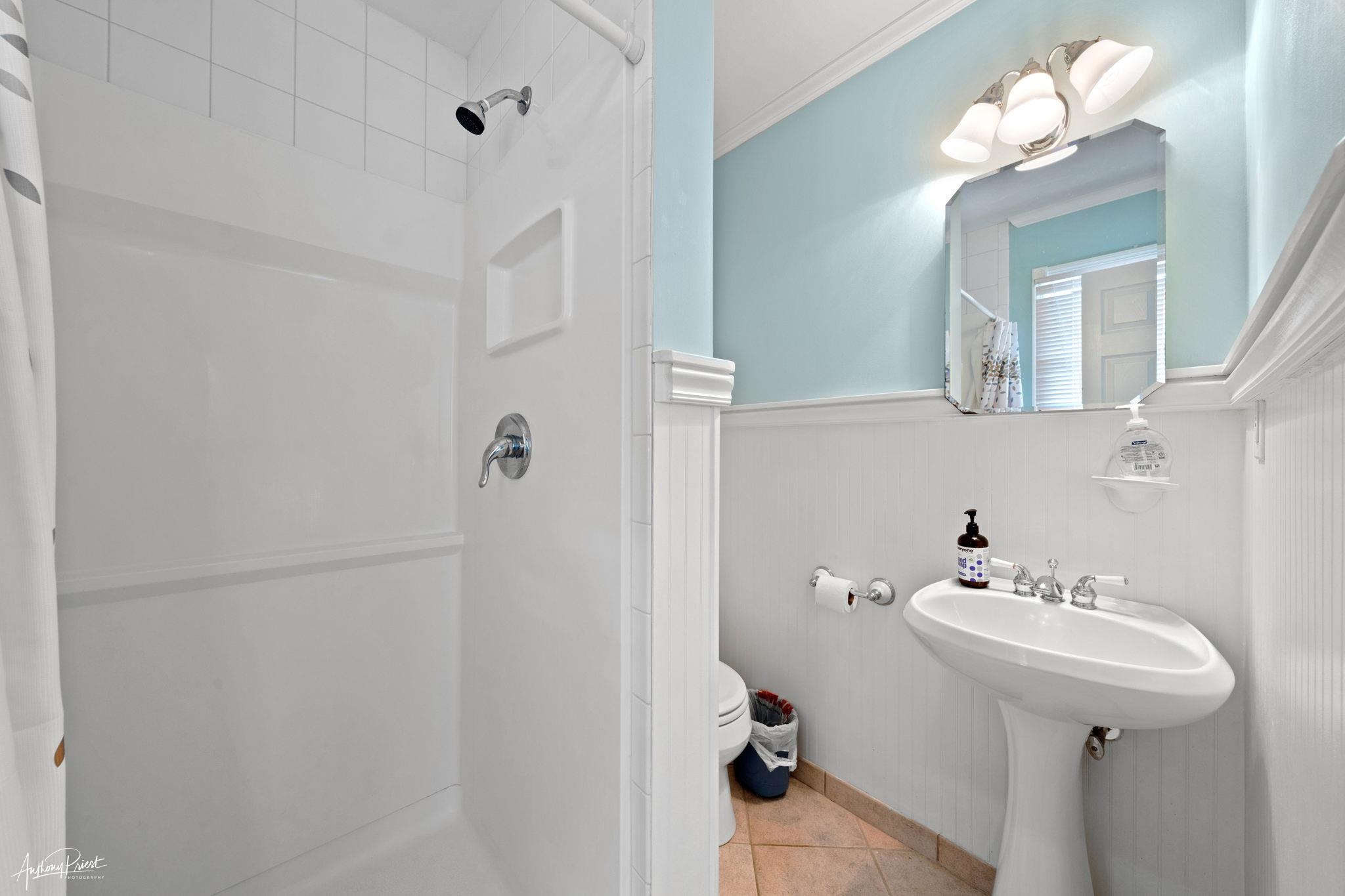 2968 First Avenue Avalon, NJ 08202 - Photo 13 of 23 a bathroom with a sink mirror and a shower