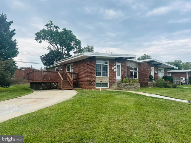 a backyard of a house with wooden floor and barbeque oven