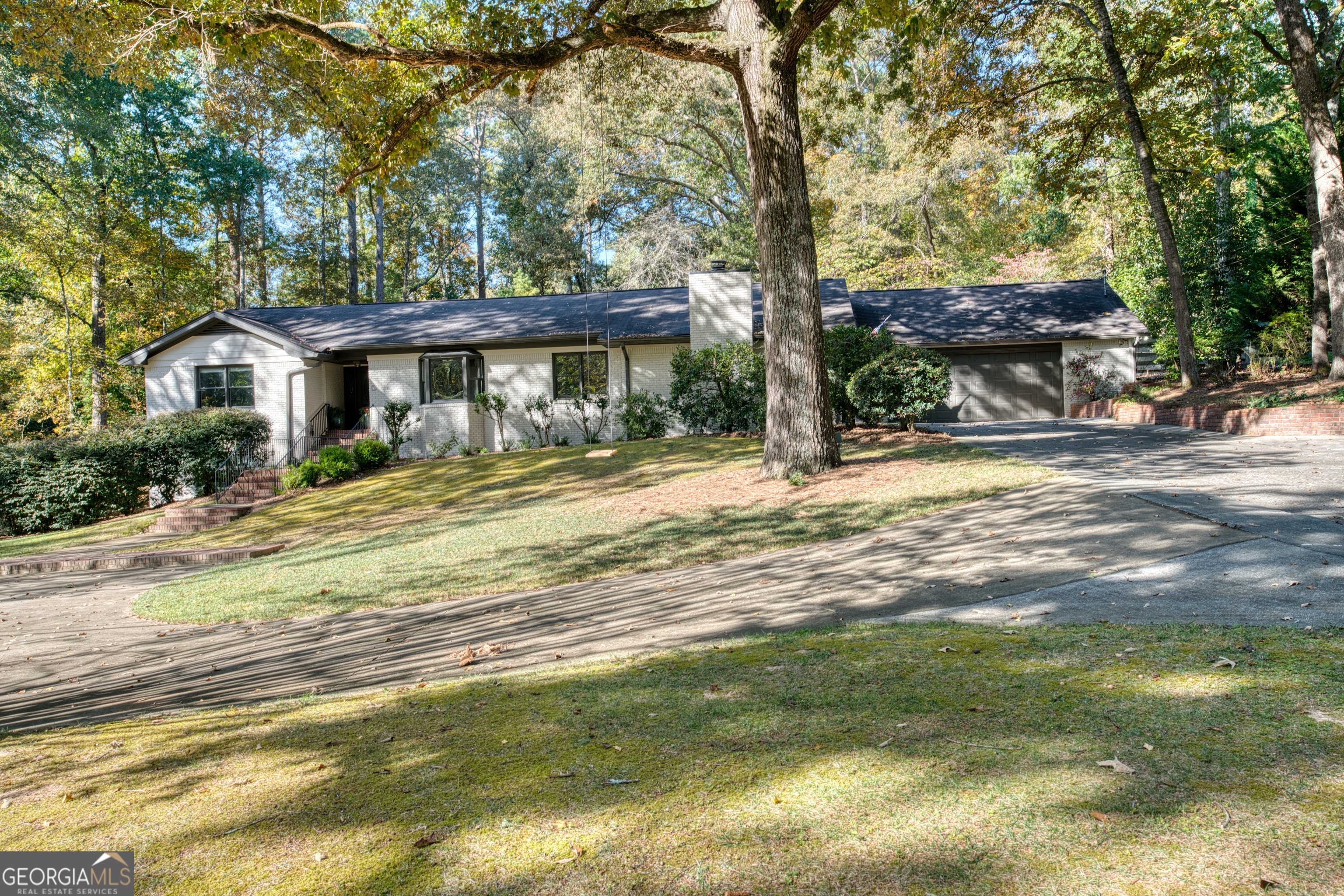 a view of a house with a tree in a yard