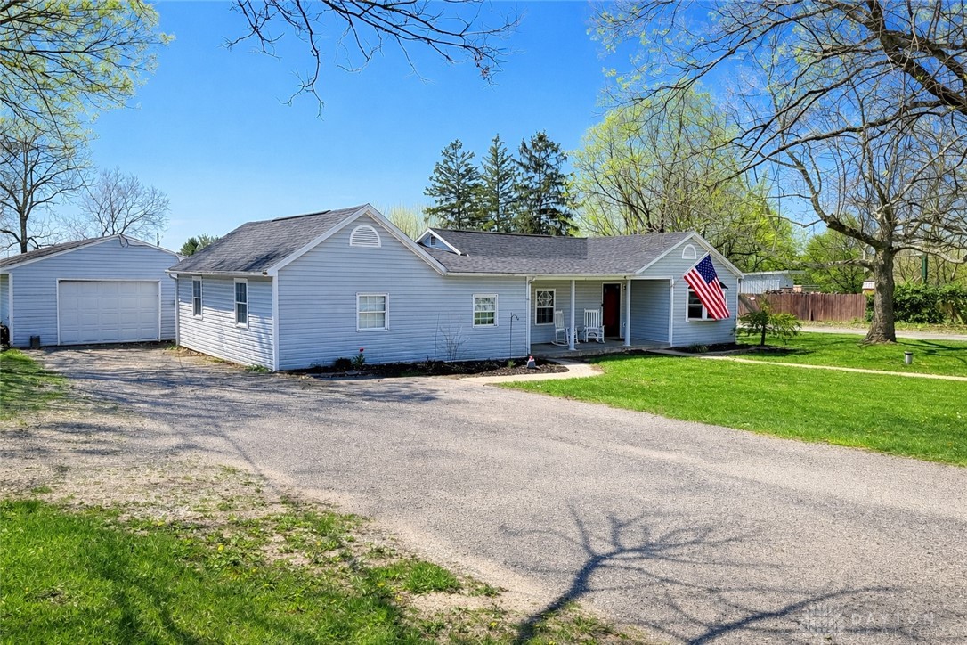 6800 Farmington Road Miamisburg, OH 45342 - Photo 32 of 32 This charming home offers a welcoming facade with a detached garage, set on a bright, sunny day.