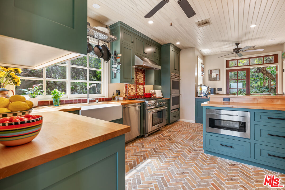 1411 Columbia Drive Glendale, CA 91205 - Photo 21 of 45 a kitchen with stainless steel appliances kitchen island granite countertop a stove and a sink