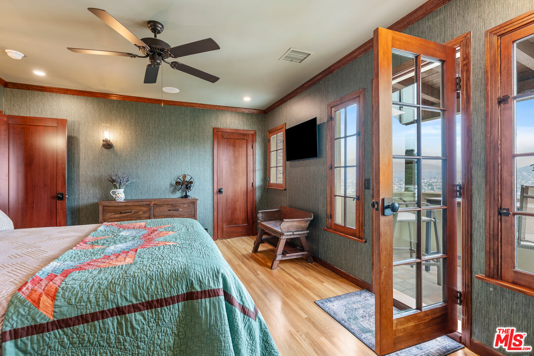 1411 Columbia Drive Glendale, CA 91205 - Photo 34 of 45 a bedroom with a bed and a chandelier