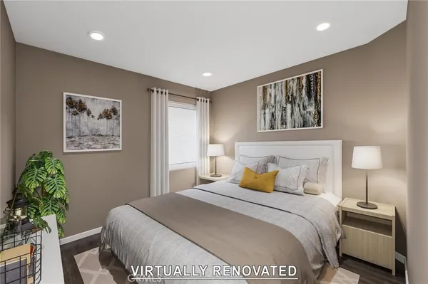 a bedroom with a bed and a painting on the wall