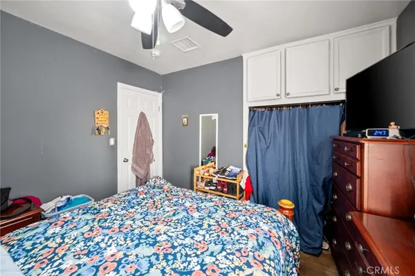 a bedroom with bed and wooden floor
