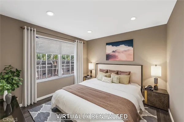 a bedroom with a large bed and a large window