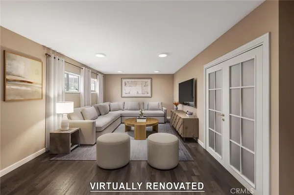 a living room with furniture a large window and a flat screen tv