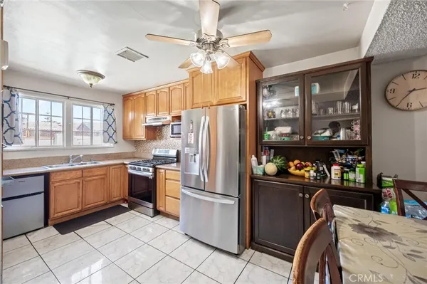 a kitchen with granite countertop stainless steel appliances a sink counter space and a window