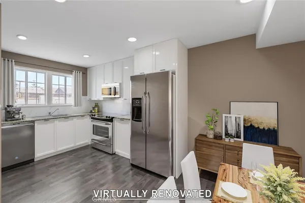 a kitchen with stainless steel appliances a refrigerator a stove a sink dishwasher and white cabinets with wooden floor
