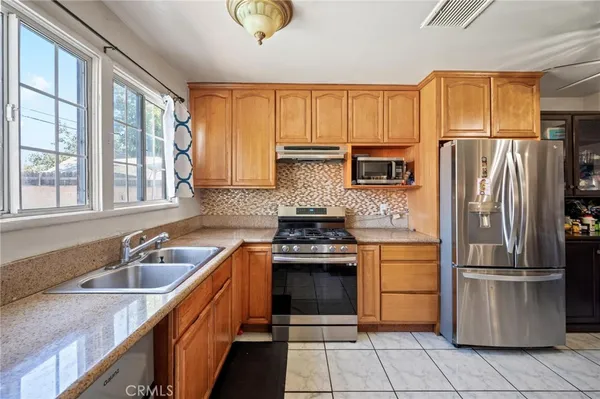 a kitchen with a sink stove and refrigerator